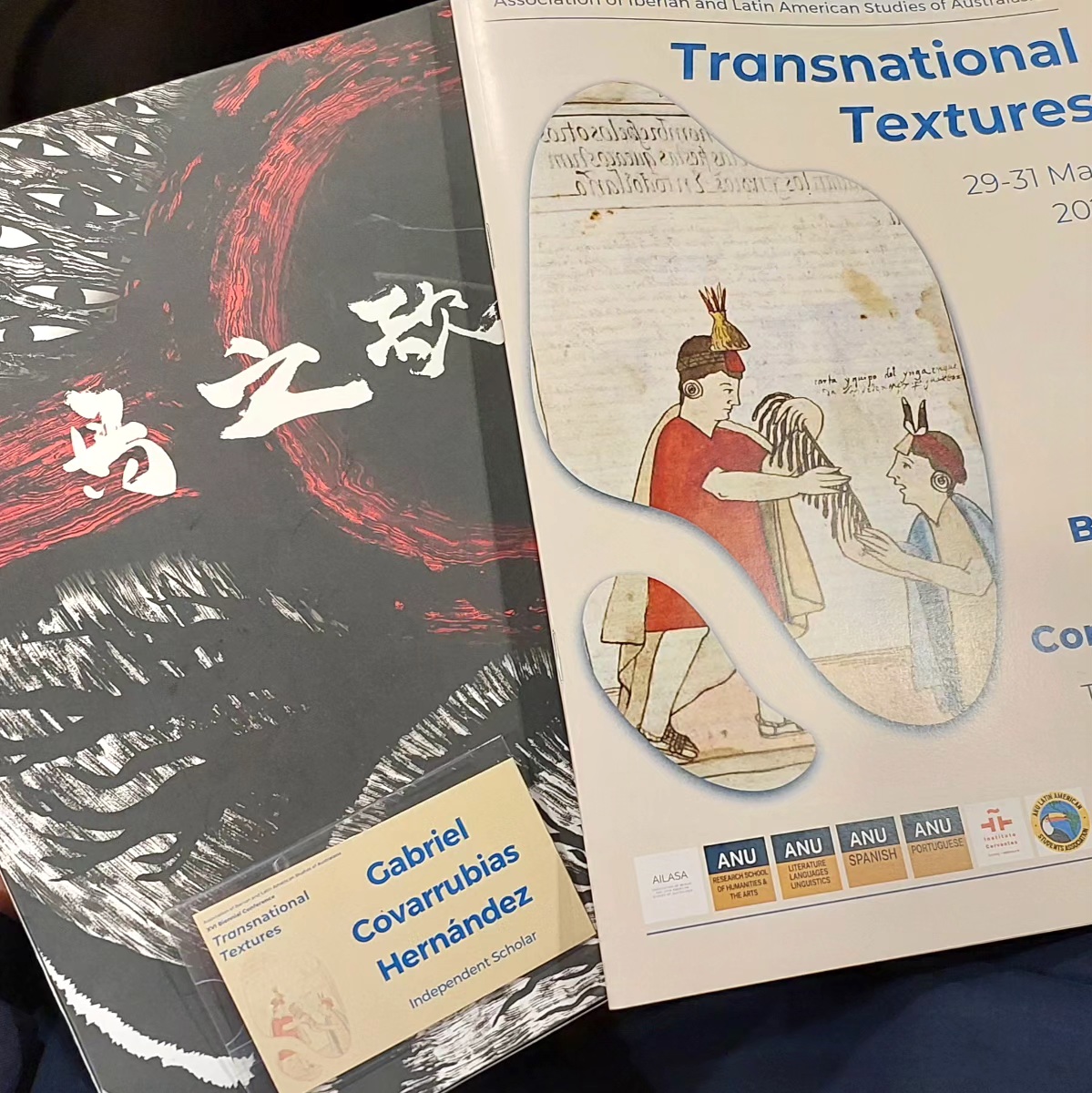 The Songs of Birds beside the Transnational Textures conference programme and Gabriel Covarrubias’s name badge